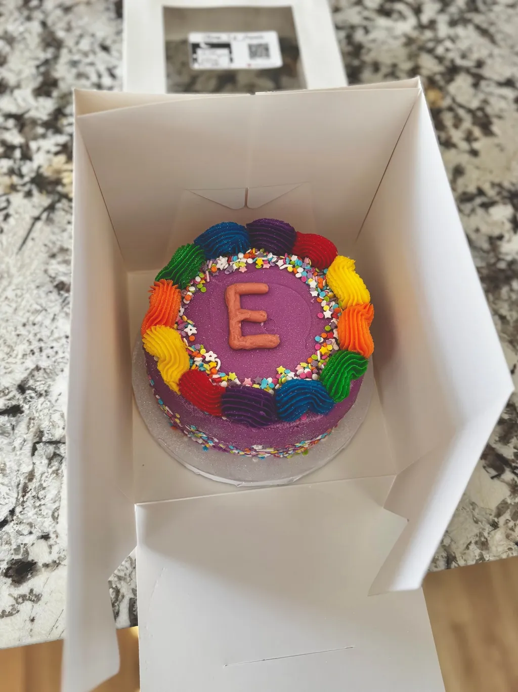 Colorful rainbow birthday cake with sprinkles